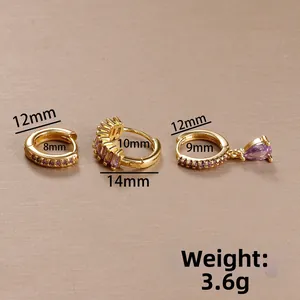 Detailed macro view of gold-plated piercing earrings set with purple zircon crystals
