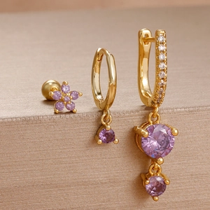 Detailed set of three gold-plated earrings with purple zircon and floral accents