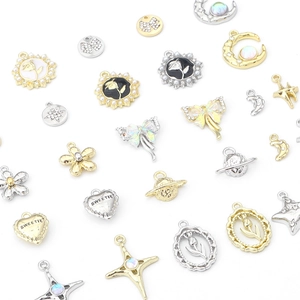Vintage gold and silver alloy pendants featuring hearts, stars, and planets for jewelry making