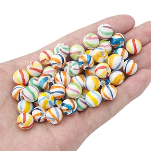 Hand-painted colorful striped ceramic beads for DIY jewelry making held in hand