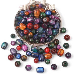 Mix of colorful resin beads with celestial star pattern in a decorative metal tray