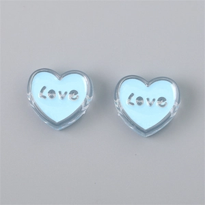 Detailed view of heart-shaped blue acrylic beads with silver Love letter inlay for DIY jewelry