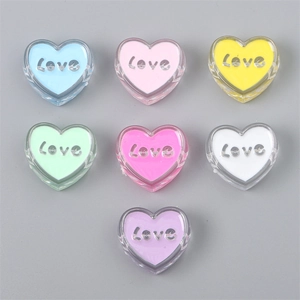 Close-up of seven colorful acrylic heart beads with embossed silver Love lettering