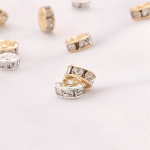 Detail view of gold and silver plated spacers with embedded zircons for DIY jewelry making
