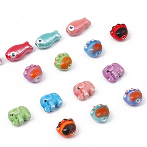 Colorful hand-painted fish and elephant ceramic beads for DIY jewelry and crafts