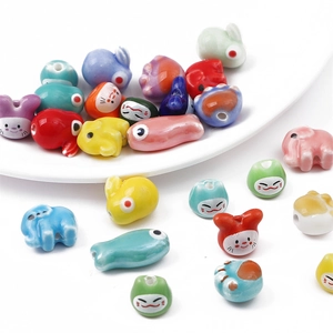 Detailed view of colorful handmade ceramic animal beads with glossy finish for DIY jewelry