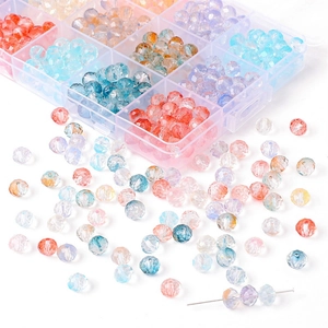 Macro view of multi-color faceted glass beads in a clear storage box for DIY jewelry making