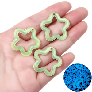 Close-up of luminous acrylic star charms for DIY jewelry making with glowing effect