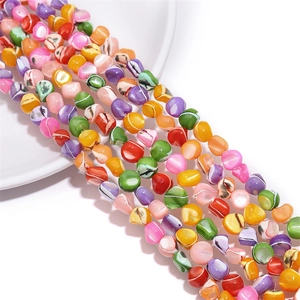 Macro detail of irregular multi-colored shell beads for DIY jewelry and necklace crafting