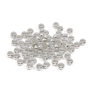 Macro shot of silver plated copper crimp beads and metal spacers for DIY jewelry making