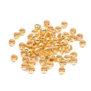 Close-up of golden mirror polished hollow round spacer beads for jewelry making