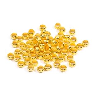 Bulk shiny gold copper spacer beads for DIY jewelry making displayed on white background