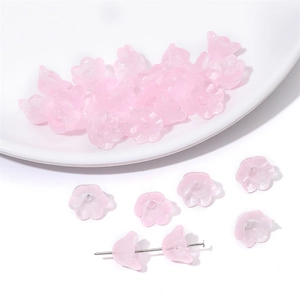Macro detail of pink translucent lily of the valley glass beads for DIY jewelry making