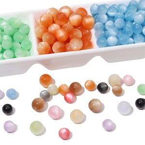 Cuentas de resina ojo de gato para joyería DIY en una bandeja blanca clasificada