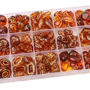 Amber acrylic bead set with gold engraved details in a multi-grid storage box