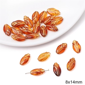 Detail of leaf-shaped amber beads with golden lines and 8x14mm size for DIY jewelry