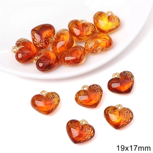 Macro detail of 19x17mm amber heart beads with baroque gold accents for DIY jewelry