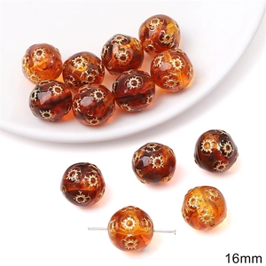 Detail of 16mm amber acrylic pumpkin beads with gold star pattern for DIY jewelry