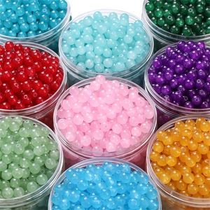 Detailed view of colorful translucent round beads for DIY jewelry in plastic jars
