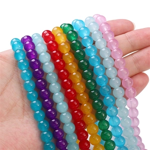 Macro shot of colorful jelly glass beads for DIY jewelry making held in hand
