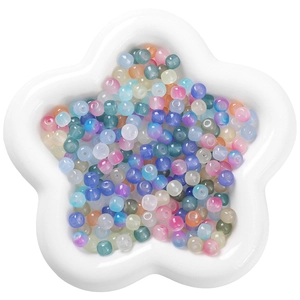 Frosted glass beads in mixed colors displayed in a ceramic tray for DIY jewelry projects