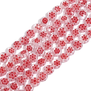 Macro shot of pink millefiori glass beads with red floral patterns for DIY jewelry making