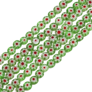 Macro shot of green Millefiori glass beads for DIY jewelry making and handmade crafts
