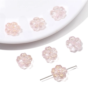 Detailed view of pink translucent cherry blossom glass beads for DIY jewelry making
