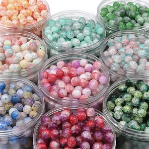 Detailed macro view of colorful cracked glass beads for DIY jewelry making in plastic jars