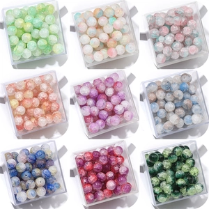 Close-up of nine-grid assorted cracked glass beads in colorful boxes for jewelry making