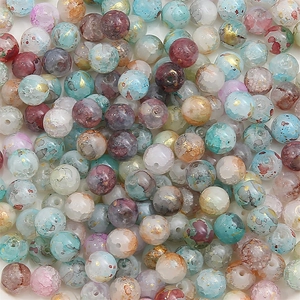 Macro view of marbled glass beads with gold foil accents for DIY jewelry making