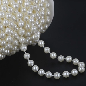 Close-up of double-row white ABS imitation pearl bead string roll for DIY bridal accessories