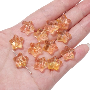 Close-up of amber star-shaped glass beads for DIY jewelry and hair accessories