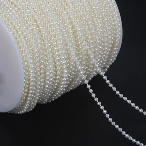 Detail view of double-strand ABS pearl chain roll for wedding dress and DIY accessories