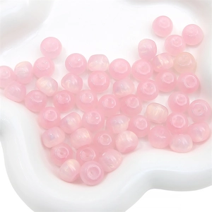 Close-up of translucent pink resin star glitter round beads for DIY jewelry making