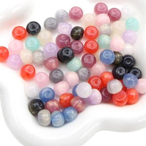 Close-up of colorful resin beads with glitter and marble texture for DIY jewelry making