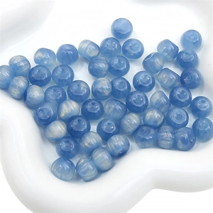 Macro detail of blue resin cat eye beads with starry shimmer for DIY jewelry making