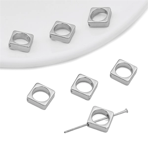 Macro detail of silver square spacer beads with center holes for DIY jewelry making