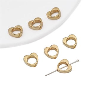 Macro view of gold plated hollow heart-shaped CCB beads for DIY jewelry making