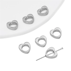 Close-up of heart-shaped spacer beads showing the large hole structure for DIY jewelry