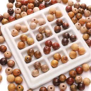 Macro view of assorted natural wood beads in various textures for DIY jewelry making