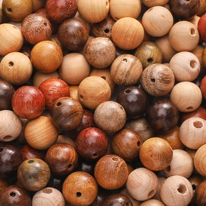 Macro shot of assorted natural polished wood beads with unique textures for DIY jewelry