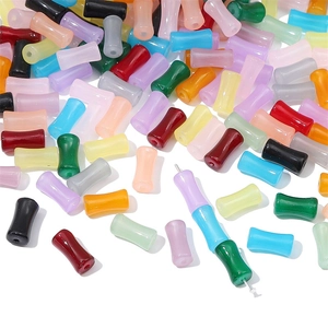 Macro shot of colorful glass bamboo-shaped beads with center holes for DIY jewelry