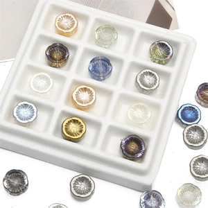 Macro shot of colorful iridescent glass flower beads in a white display tray for DIY jewelry