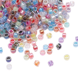 Macro shot of mixed iridescent glass seed beads for DIY handmade jewelry crafting
