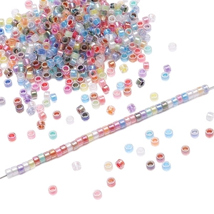 Macro shot of 2.5mm iridescent glass seed beads in macaron colors for DIY jewelry making