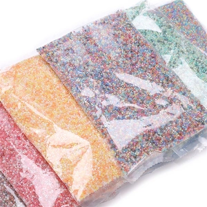 Macro shot of 2.5mm colorful glass seed beads in small pouches for DIY jewelry making