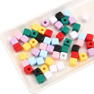 Macro detail of colorful acrylic cube beads with large holes for DIY jewelry making