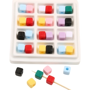Close-up of colorful acrylic square beads with center holes for DIY jewelry making