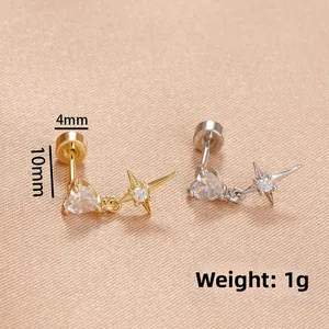 Detail of cross and zircon drop earrings in gold and silver with screw back design